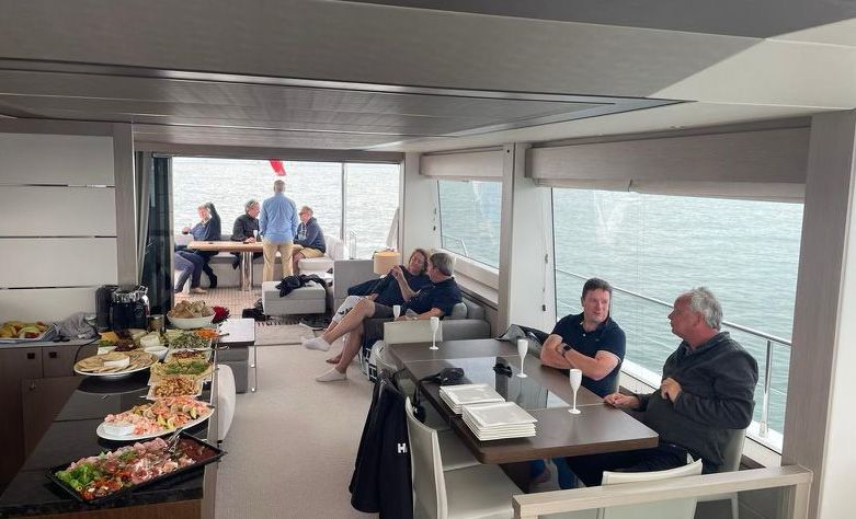 Guests talking in the saloon of a Sunseeker yacht